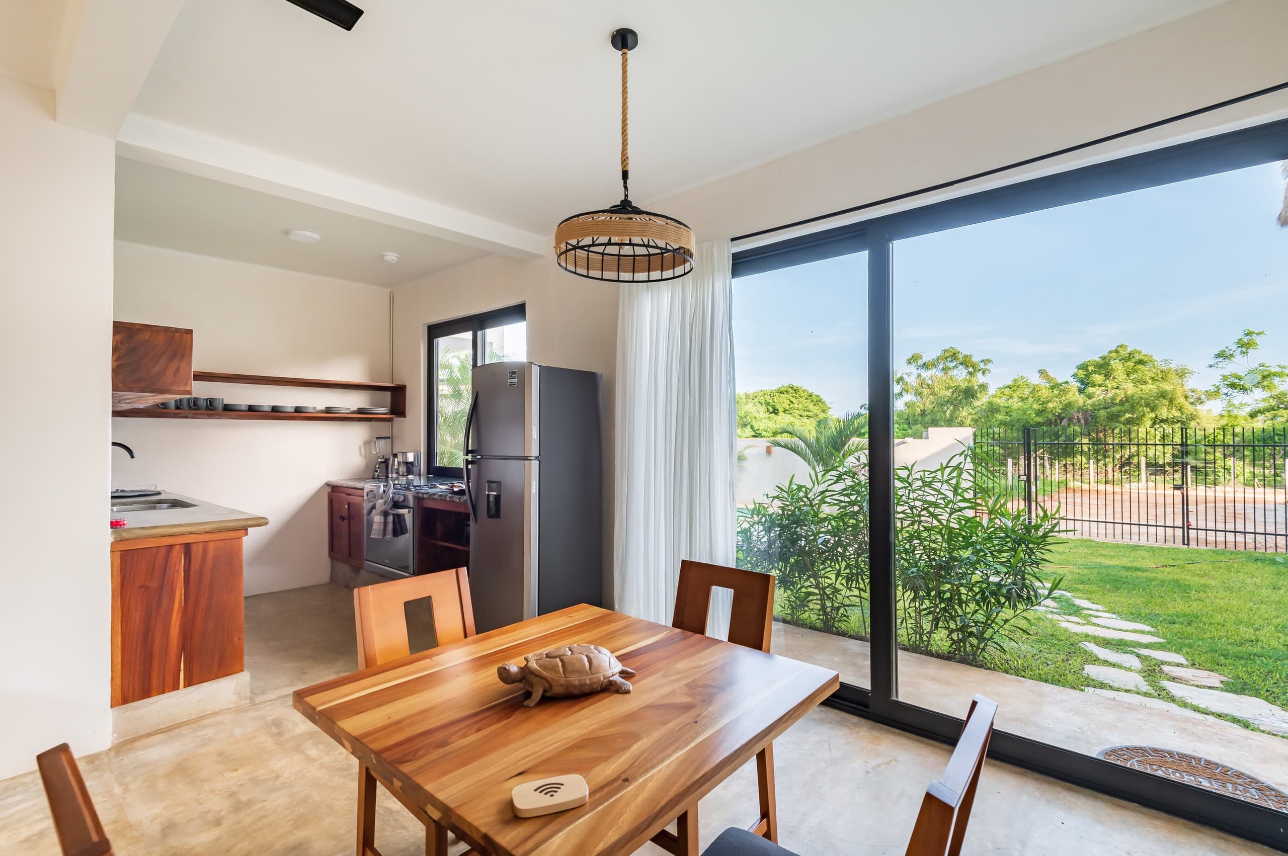 Comedor junto a un ventanal con vista al jardín